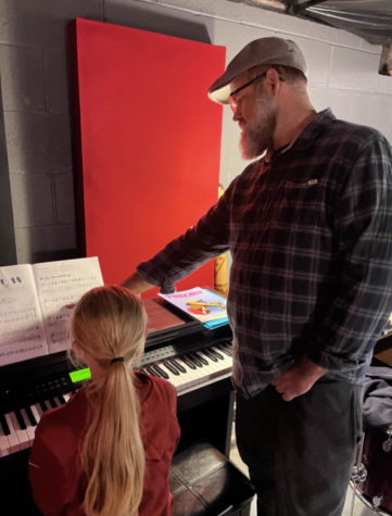 Dan Trilk teaches a student piano in his basement after school on Oct. 25. Piano is one of the many instruments Trilk teaches, as he has played it throughout the majority of his life.