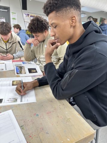 Landon Edwards is taking notes on chapter three in Art Appreciation class on January 30th. Landon is a member on Norwalks basketball team who went to state this year.