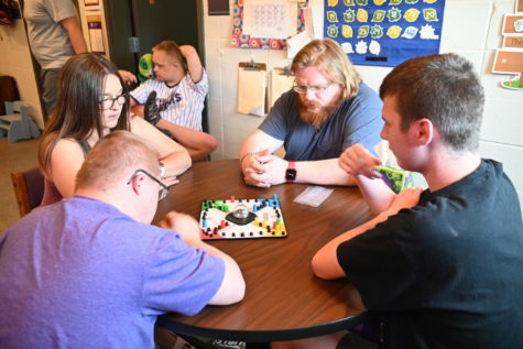 Students and a teacher are playing sorry in the Special Education room at Norwalk High School 