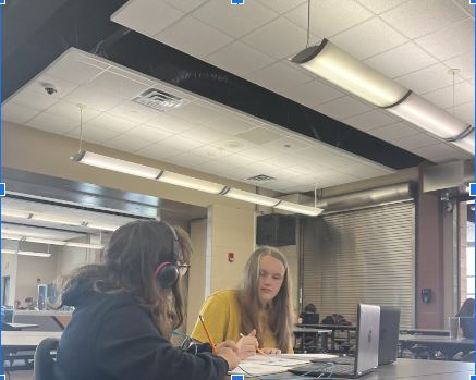 Middle school students Mackenzie Kestel (right) and Ava Streeper converse as they draw at the Norwalk High School cafeteria on Tuesday, Aug. 29, during third period. It is their study hall, and they said that they pass the time with art.