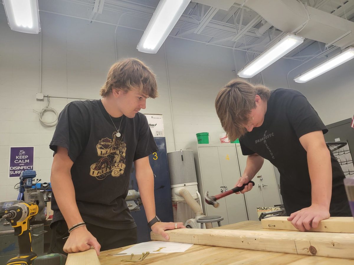Cole Wardlow (left) and Tanner Wilson construct an I beam third period Friday, Aug 25, in the Mr. Voss’  classroom. The I beam will be used to create a sawhorse, which is used to cut wood without cutting into tables. 