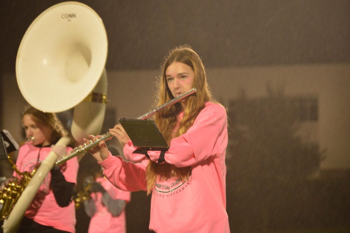 _ plays flute during halftime on Friday, Oct. 13. The band has a variety of woodwind instruments such as flute, clarinet, and saxophone. 