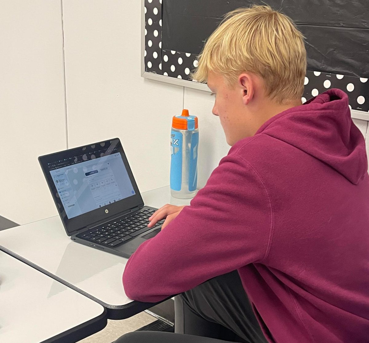 Sophomore Brayden Plourde fills out an E-Hallpass to leave the classroom in Journalism class in October. The new passes are something that students at Norwalk High School have mixed opinions about, and is a program that’s still new to students and staff members at NHS. 