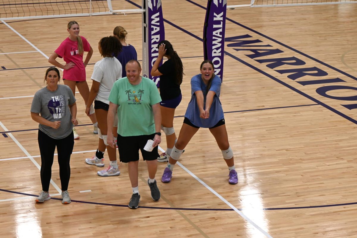 John Fulton, head coach of the volleyball team, has some fun with players on Sept. 15.  This is his second year coaching at Norwalk and his first year teaching up at the high school.