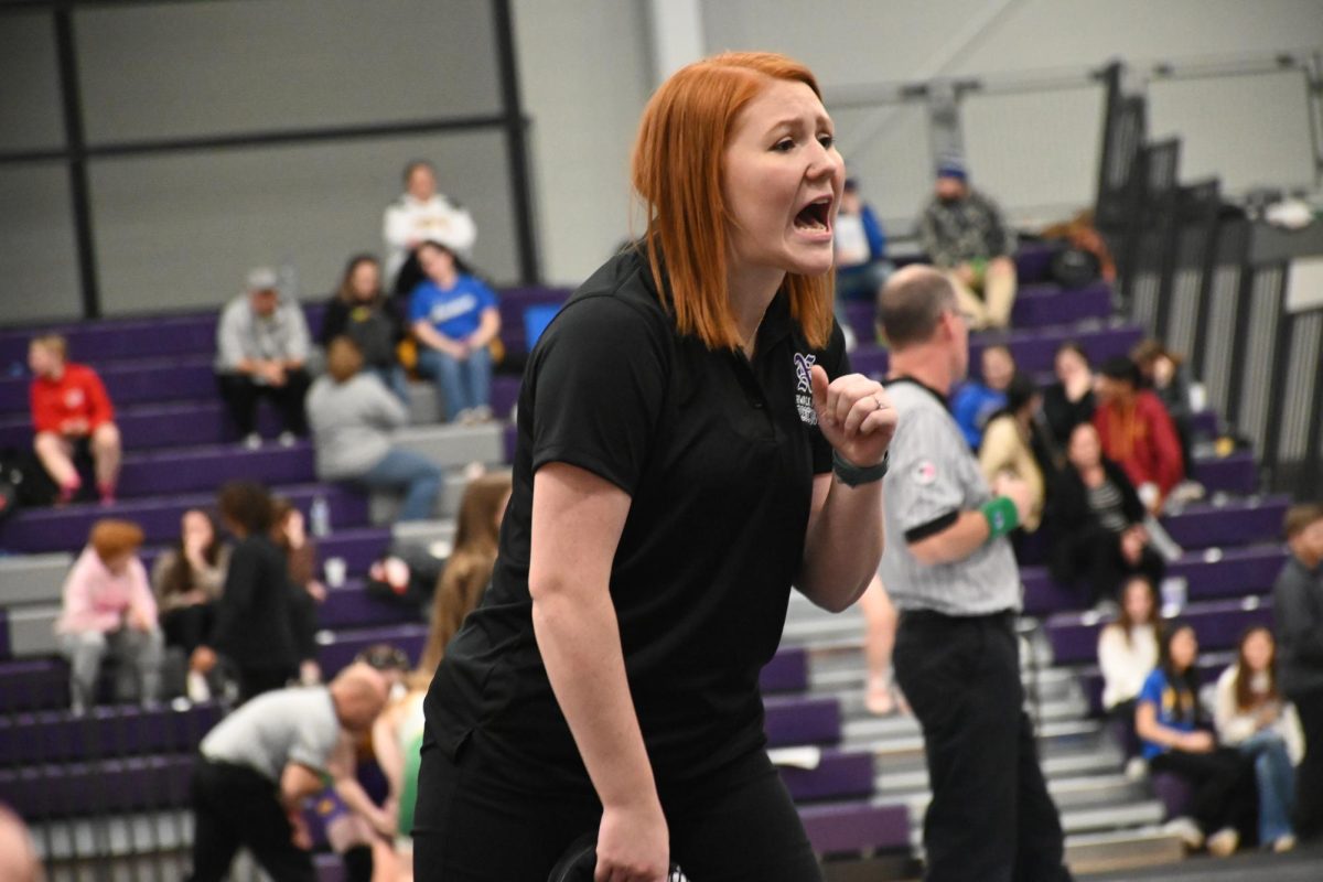 Alanah Vetterick, head coach for the girls wrestling team, cheers on her team at home during a meet last school year. The girls will wrestling in Nevada on Thursday, Jan. 4.
