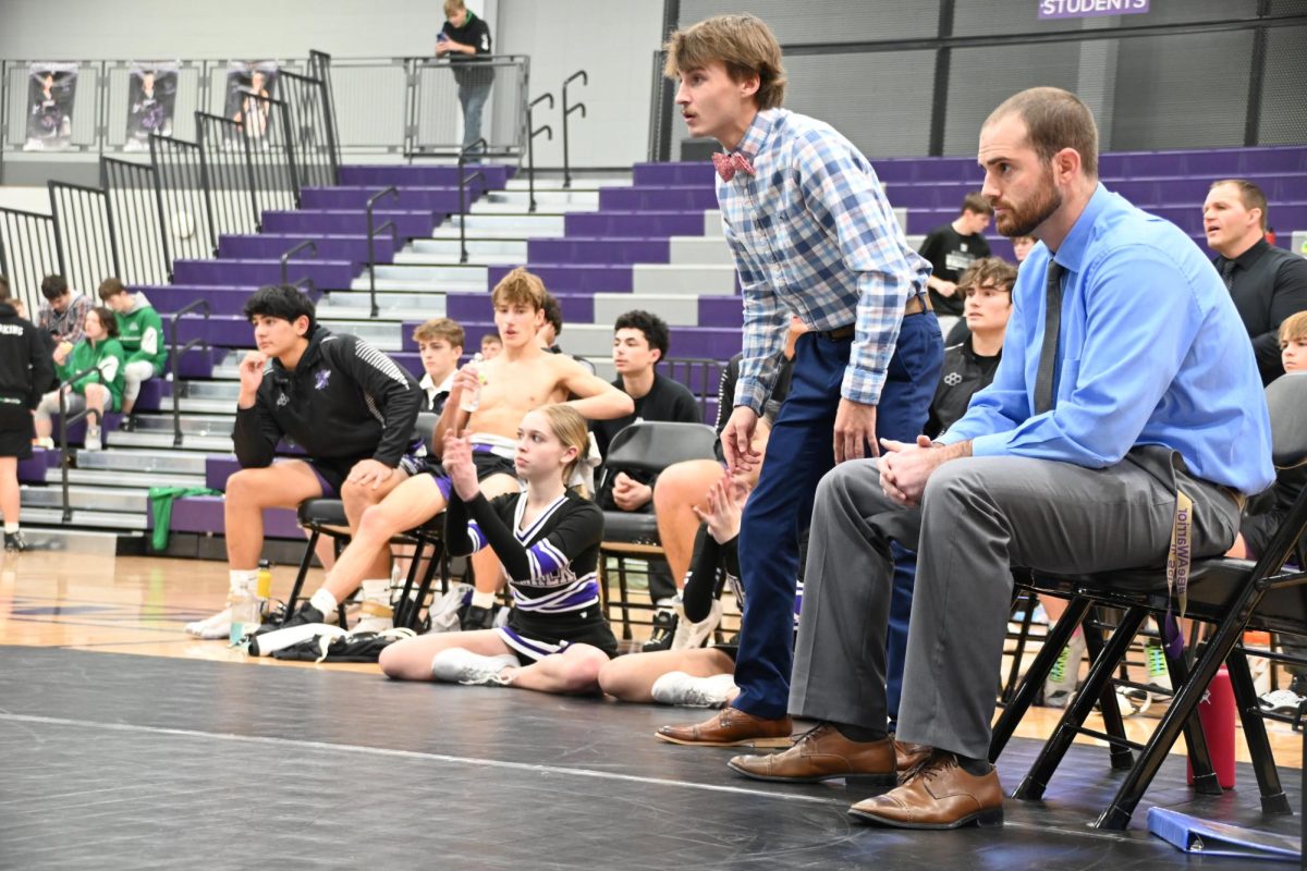 Coach Brown (right) watches as one of his players wrestles at a home meet on Dec. 12, 2023, in the NPECC. The district wrestling team wrestled this past Saturday, Feb. 10.