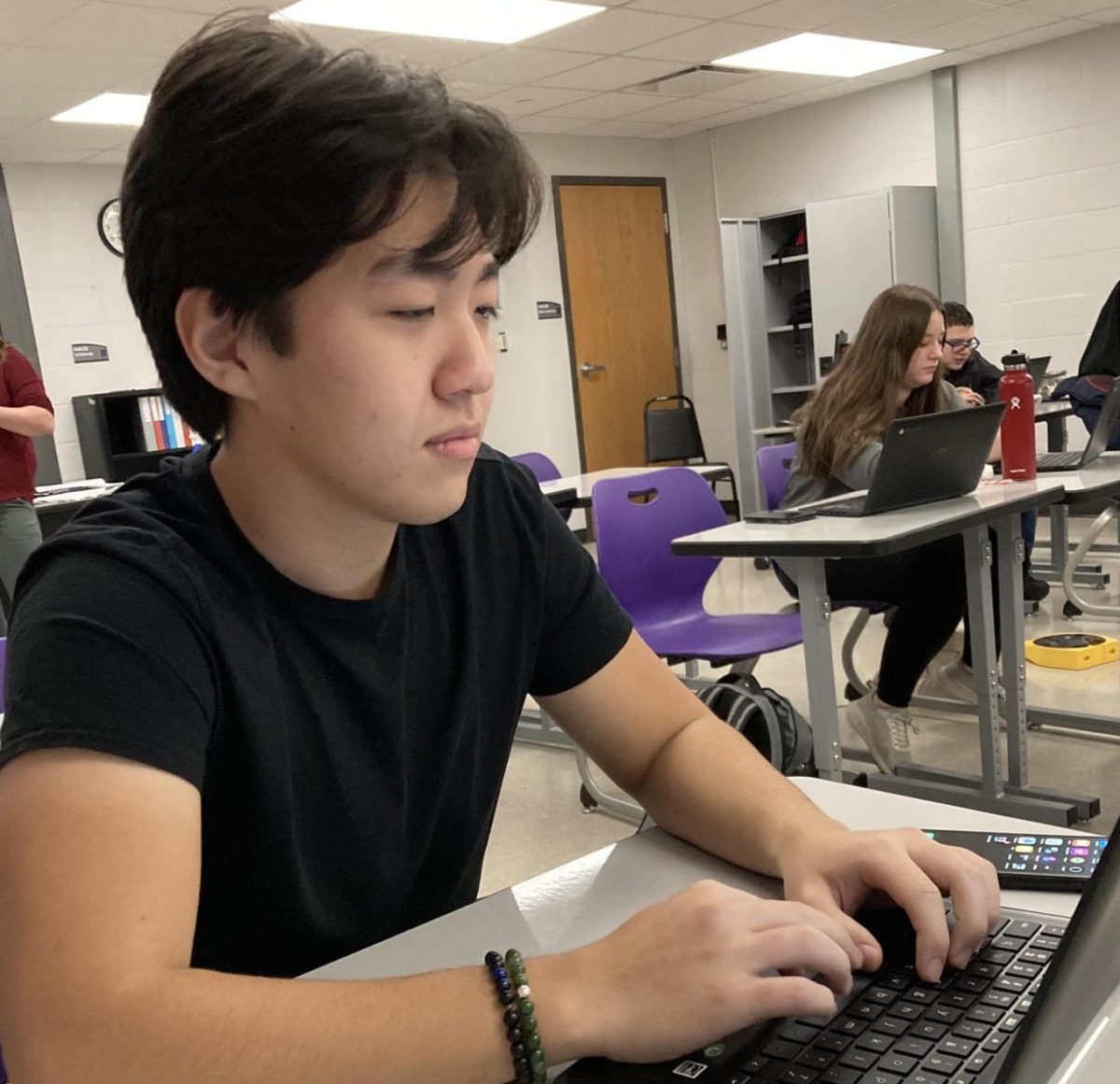 Dulguun Batzaya writes in Mrs. Thomas journalism class this past fall. Dulguun is involved in many activities such as journalism and football.