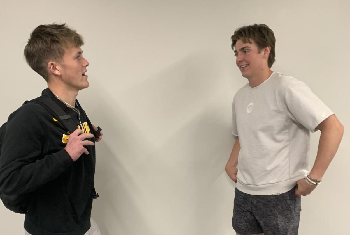Senior Grant Fletcher (left) and senior Aidan Harder talk on Monday, May 6 by the library. Fletcher and Harder are both co-leaders for the Senior Assassin game.