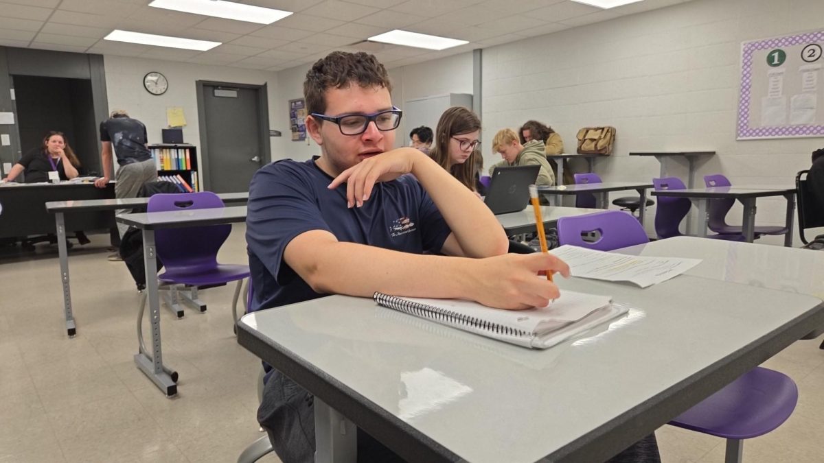 Tyler Davis works on a story in May in Mrs. Thomas’ room. Davis wrote many stories this semester covering topics such as Senior Assassin, the fashion show, and the Warrior Cafe.