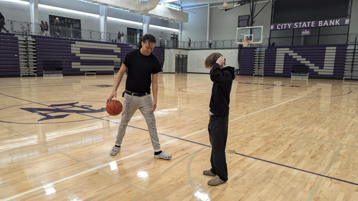 Senior Adrian Rosenburg and sophomore Joseph Ceretti play basketball during gym class on Thursday, Aug. 29, at Norwalk High School.