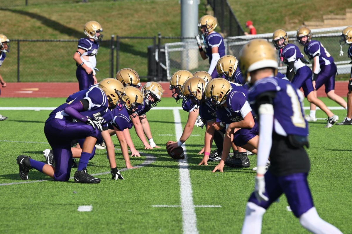 The freshman team warms up against each other pre-game on Sept. 20 at Mineart Field. The Warriors played the ADM freshman team at 4:45 p.m., and the varsity team played at 7:30 p.m.