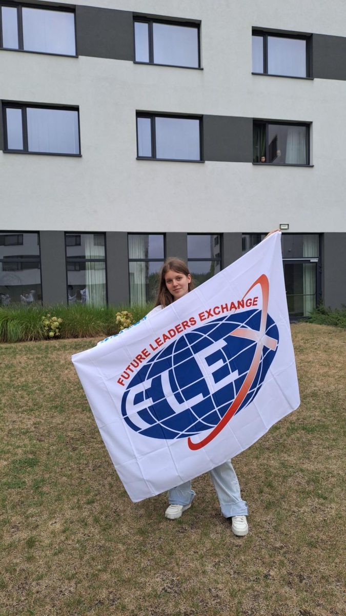 Foreign exchange student Ivanna Sherstiuk holds up a FLEX program flag. FLEX (Future Leaders Exchange Program) allows students from all over the world to compete for a scholarship that provides an opportunity to attend a U.S. high school. 