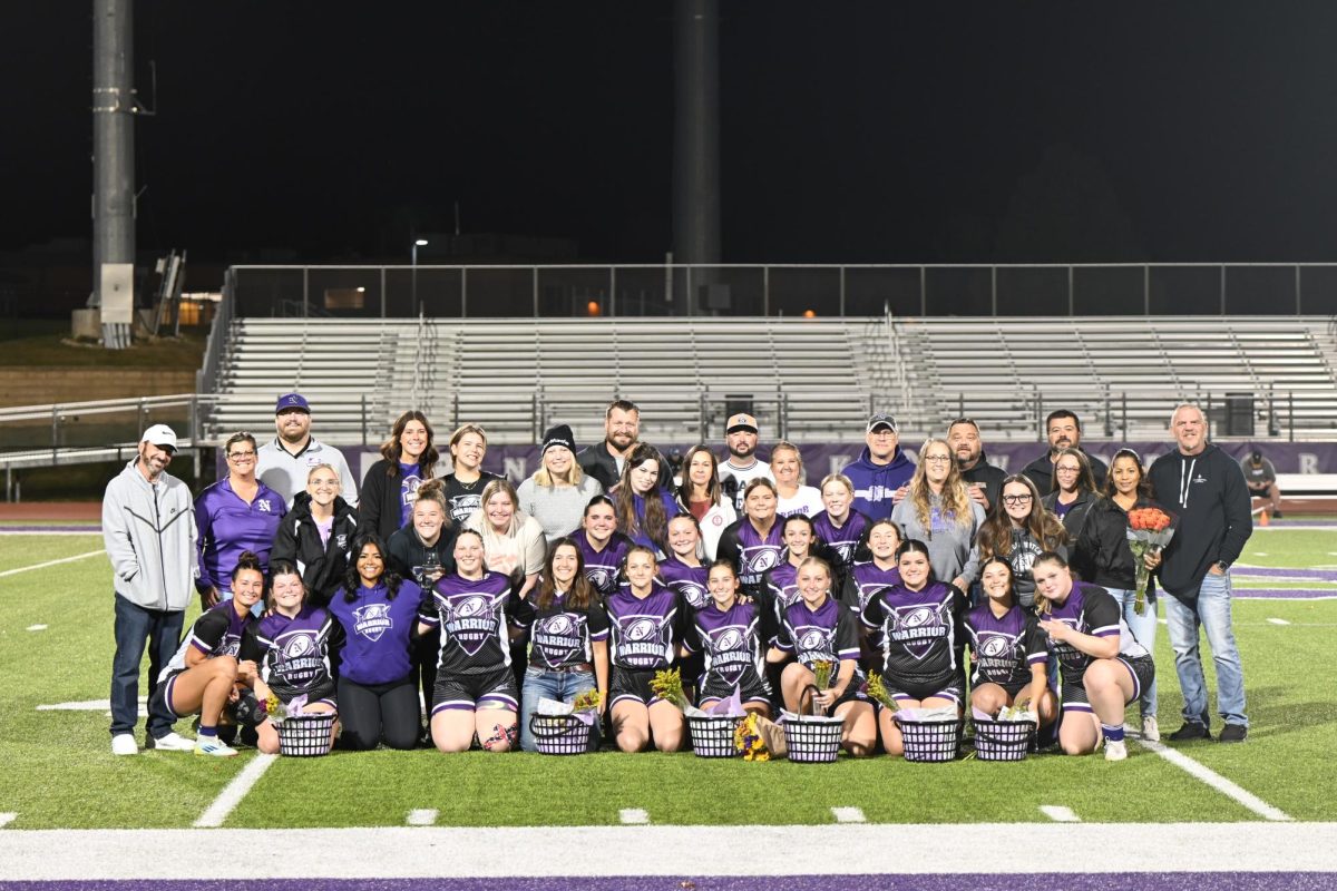 A team picture of the players, coaches, and senior parents. Seniors receive gift baskets as a sign of appreciation from their team. 