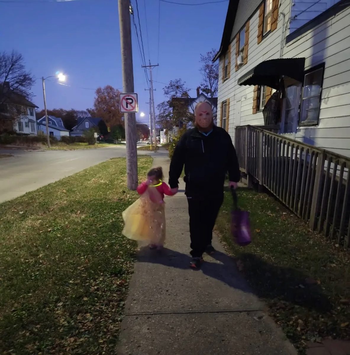 Two trick-or-treaters walk the streets on Thursday, Oct. 31 in Norwalk while going door to door asking for candy. 