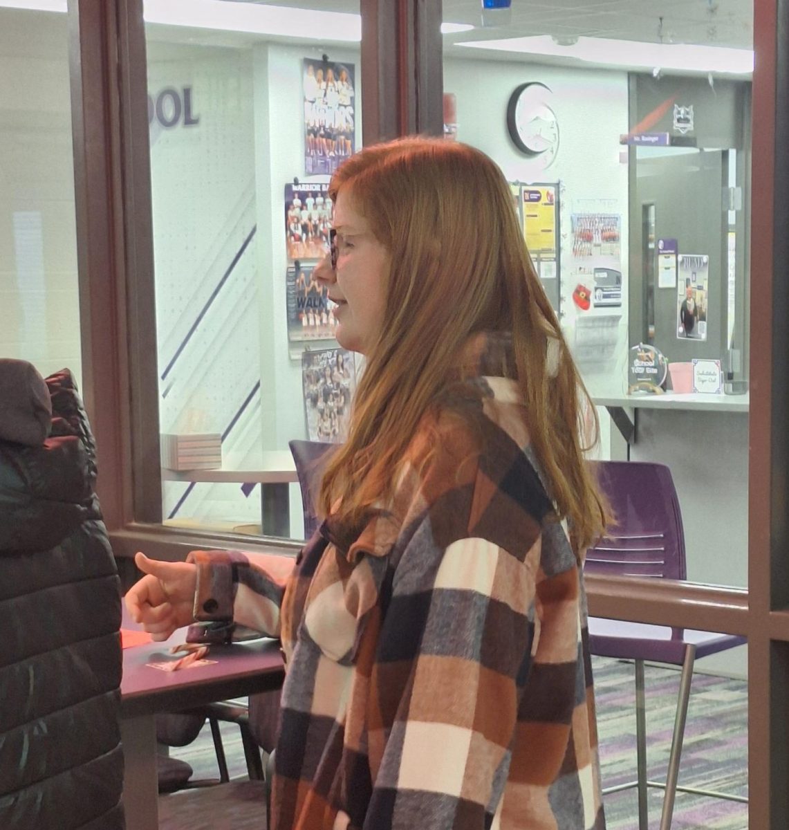 Zoe Voogd sells candy canes on Dec. 20. Before school, Voogd sold candy canes for Student Council to help fundraise money. 
