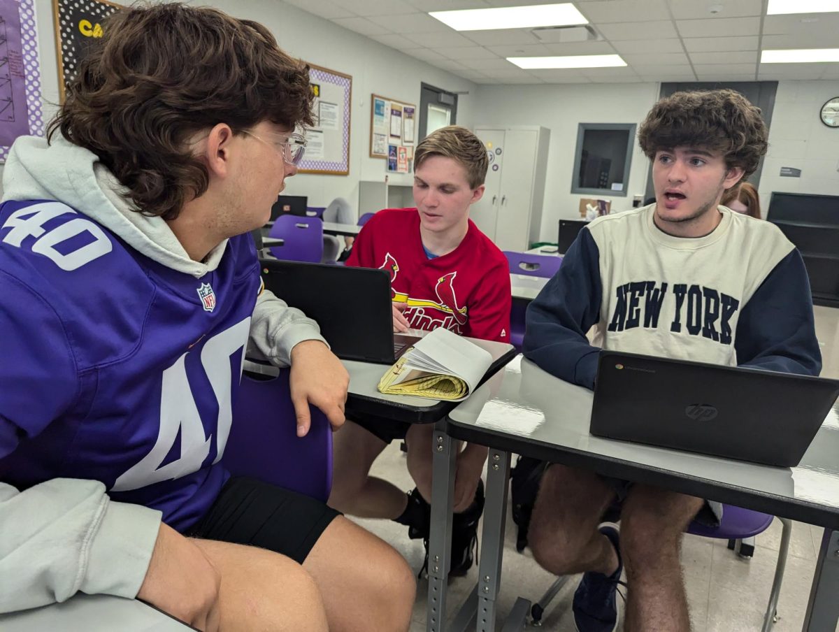 Isaac Binder (left), Eli Geisler, and Keegan Johnson discuss a new assignment in journalism class. Binder said he feels senior year has been easiest, and junior year was hardest.