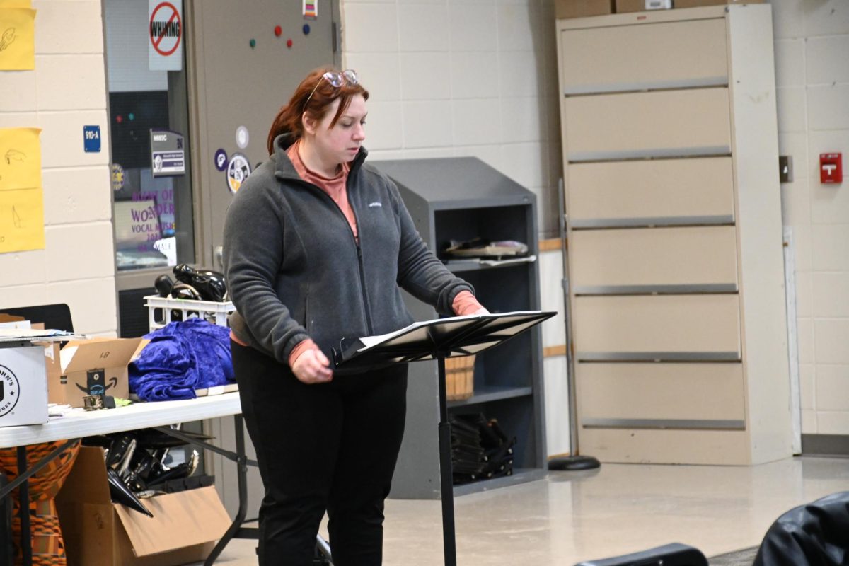 Mrs. Ommen helps the sopranos in the choir room on Feb. 17. Ommen sometimes sings with certain parts in order to help them learn the music. 
