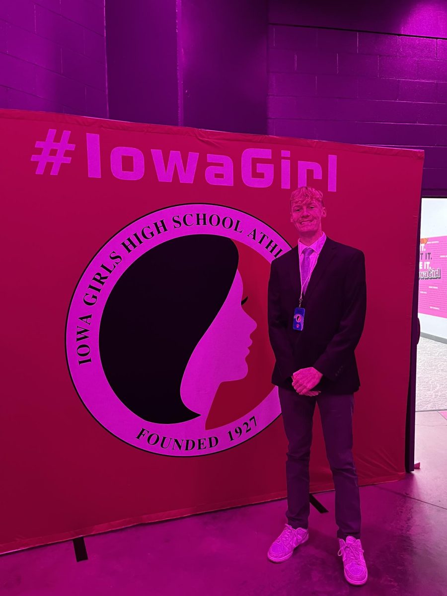 Here, I pose for a picture in front of the Iowa Girls High School Athletic Union banner inside the tunnel. The tunnel leads out to the arena and is where both athletes and media members enter on the floor level.