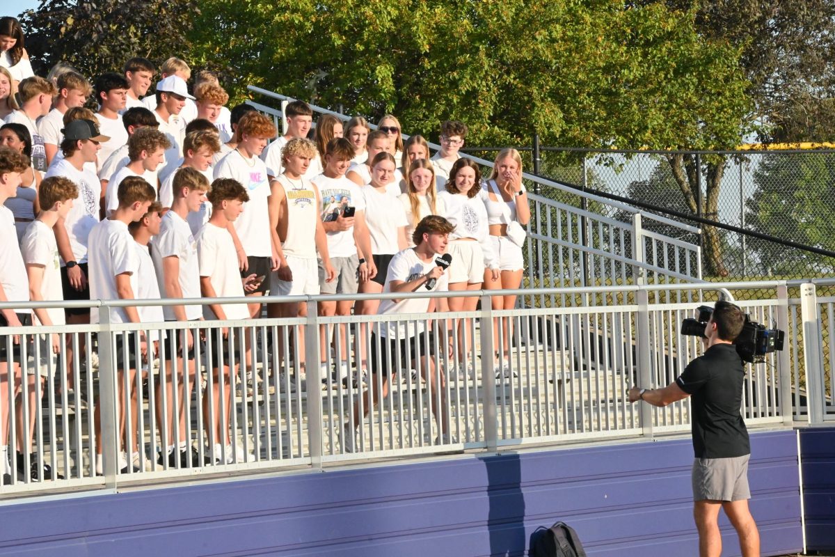 Junior Keilan Selby (center) yells into the camera pre-game on Friday, Aug. 29, at Indianola. Local 5 News was on the sideline covering the schools making their debut in 5A.
