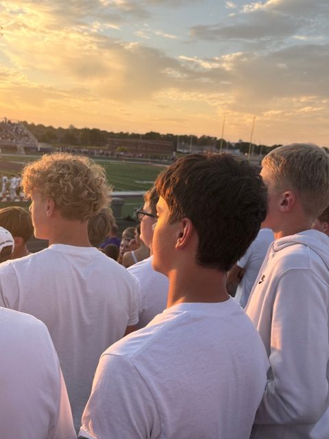 Blake Overholser (right) and the Norwalk student section watch Norwalk's football team lose to Indianola on Friday, Aug. 29, at Indianola High School. It was Blake Overholser's first time cheering for Norwalk as a high schooler.