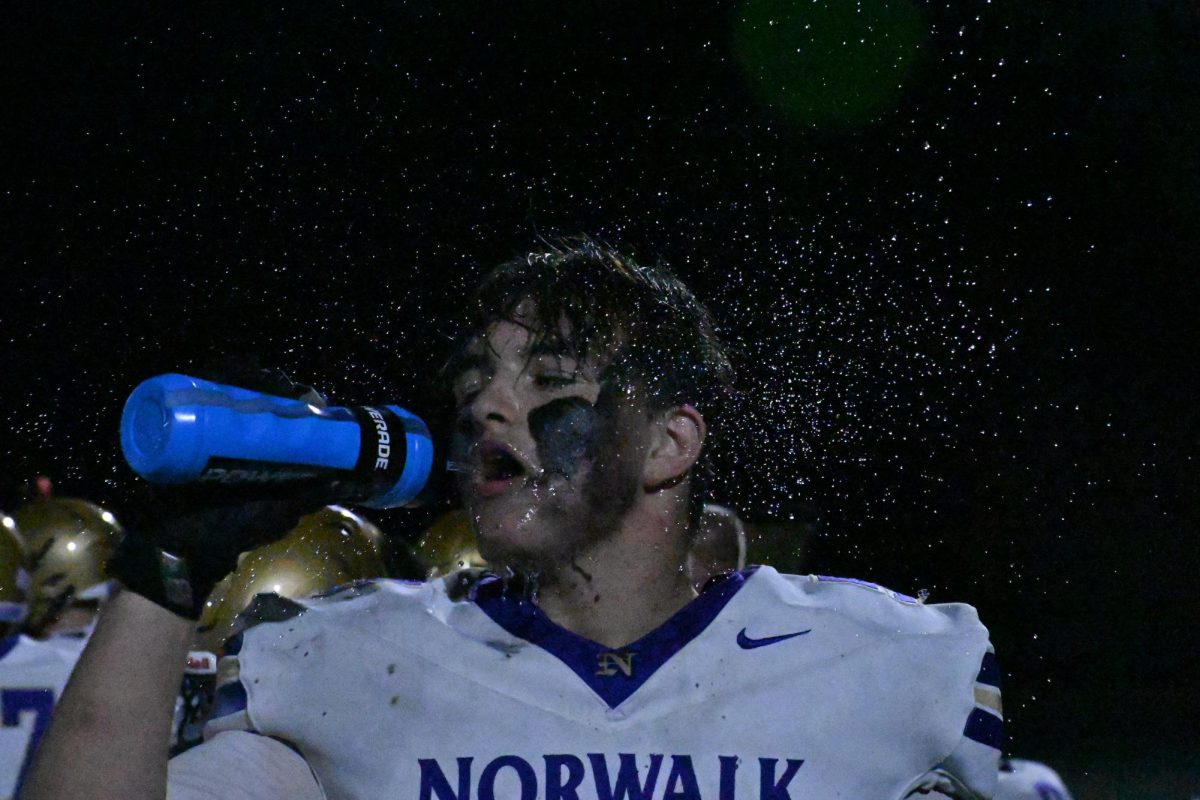 Senior Rhylee Harringa hydrates after a play in the third quarter against Ames on Friday, Sept. 19, in Ames, Iowa. 