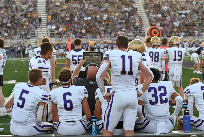 Brady Wilkening (left), Isaac Peter, Jamison Giesemann, and Victor Esparza listen to coach Tom Scallon as he tells them future plays on Friday, Sept. 5, at Indianola High School. The Norwalk Football Team will take on the defending 5A champion Southeast Polk at 7 p.m. Friday, Sept. 12, at Norwalk High School.