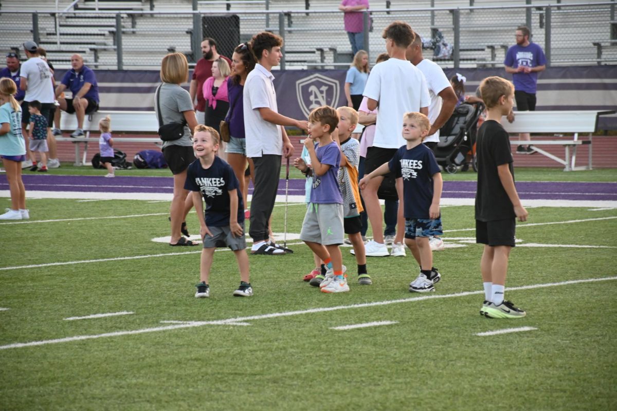 A group of boys play a football game in the middle of the field. They say “500 is their favorite game to play.”
