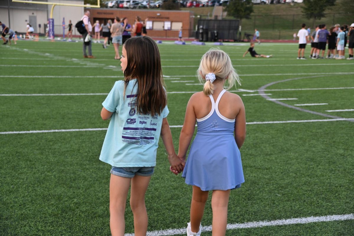A couple of Norwalk kids walk around the football field looking for some activities to participate in during the youth activities time. The activities consisted of limbo with the dance team, a basketball pop up with the girls basketball team, obstacle course with the volleyball team and many other activities. 
