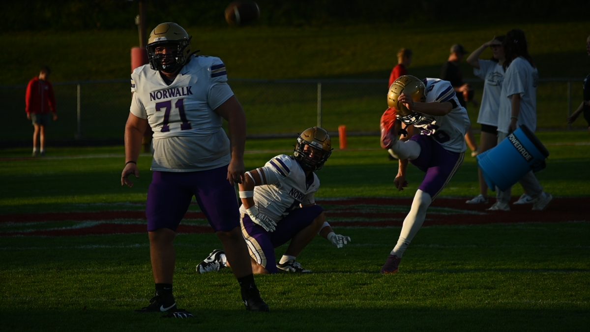 (From left) Nick Schiller, Brady WIlkening, and Greer Langel practice field goals pre game at Iowa City on Friday Sept. 26. Langel holds to Norwalk record for longest field goal at 52 yards