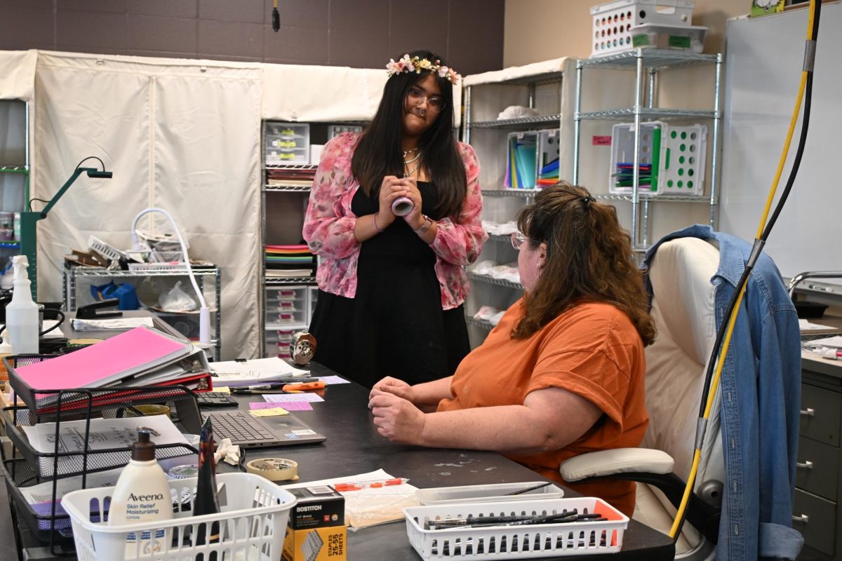 Emily Diego (left) talks with Mrs. Riemersma about different glazing techniques she could use for her bowl. Diego is a sophomore.