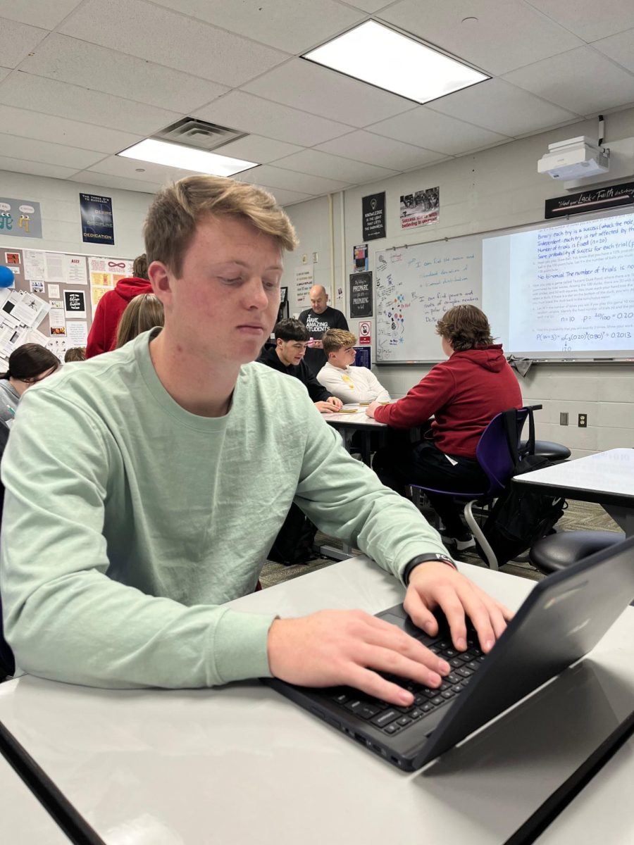 Jacob Gear checks his computer during AP Stats on Jan. 7 in Mr. Evan's room. Gear is planning to attend Dordt University next fall.