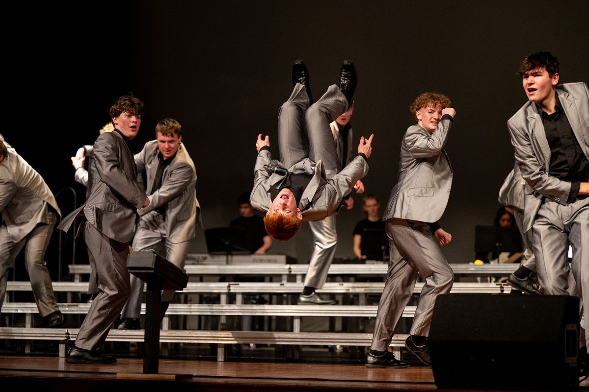 Greer Langel does a back flip Jan. 17 during a show choir competition at Glenwood High School in Glenwood, Iowa. The show choirs will give their final performance of the year this weekend.