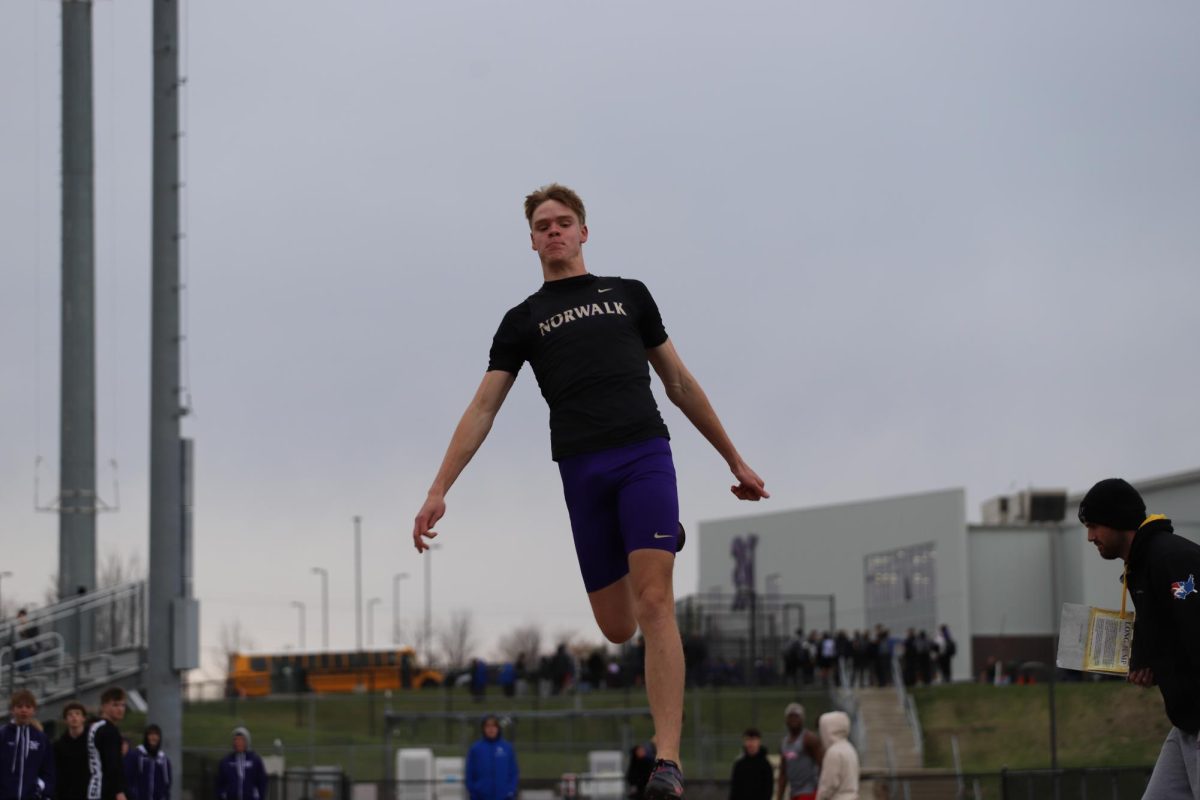 Kaiden Kunze long jumps on April 6 at Warrior Stadium. Kunze recently jumped the fifth longest long jump in Iowa history.